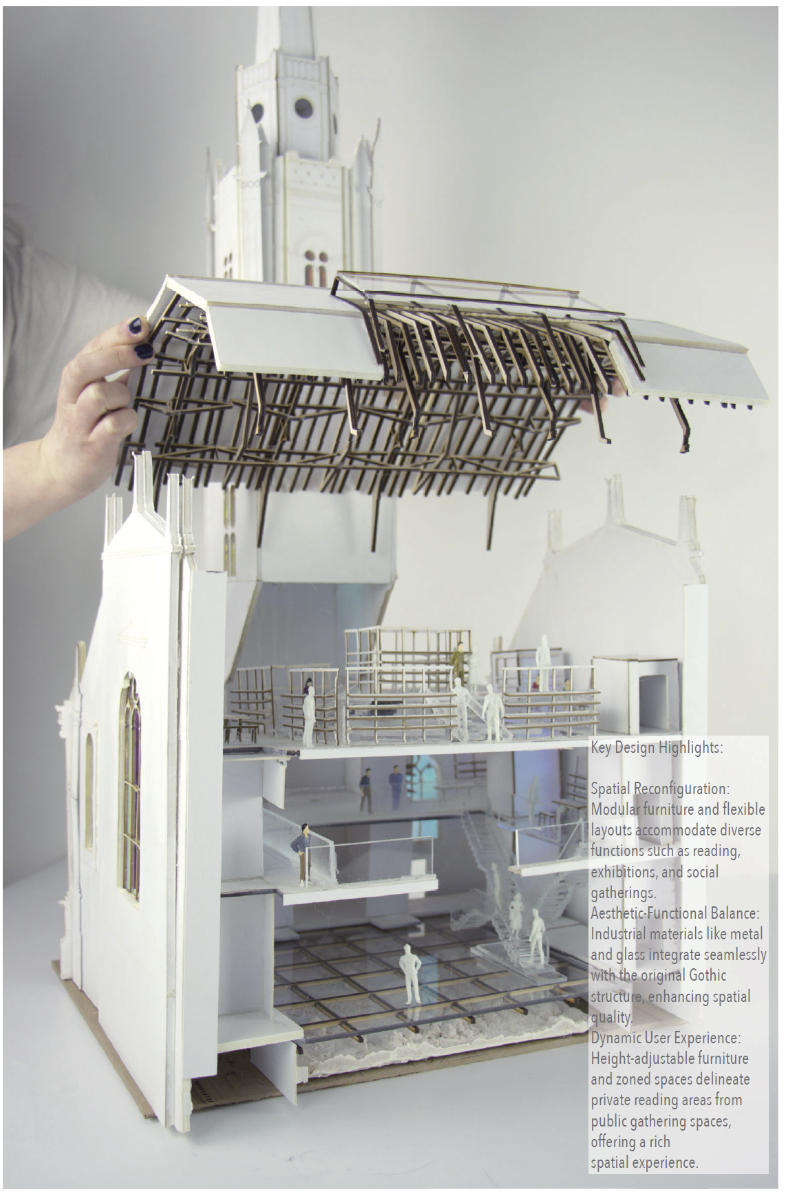Hand lifting the roof structure off the sectional model of the Tron Kirk library